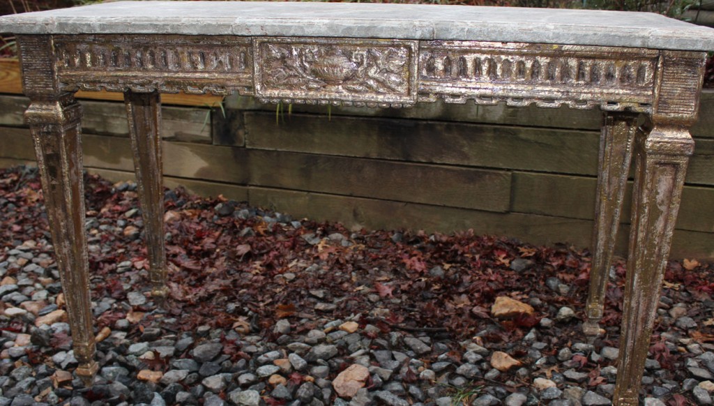 Detail of aged gilding on the apron of the console