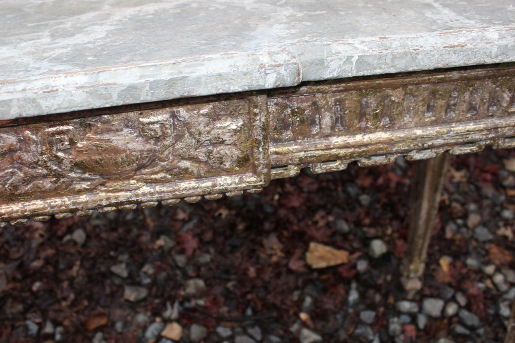 Detail of distressed gilding on apron of console